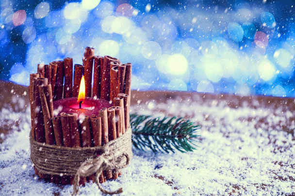 Snow Falling On Red Cinnamon Stick Christmas Candle Burning. Vintage Filter Applied. - Photo, Image