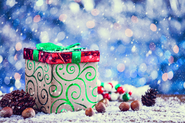 Snow Falling On Red And Green Christmas Gift Box Vintage Filter Applied. - Photo, Image