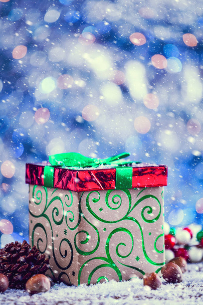 Snow Falling On Red And Green Christmas Gift Box Vintage Filter Applied. - Photo, Image