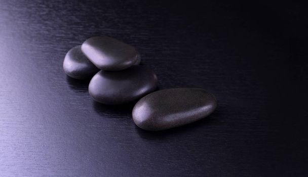 black stones for Thai spa on black wooden background - Фото, зображення