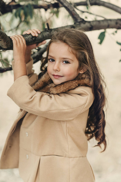 in autumn forest little girl with long hair - Φωτογραφία, εικόνα