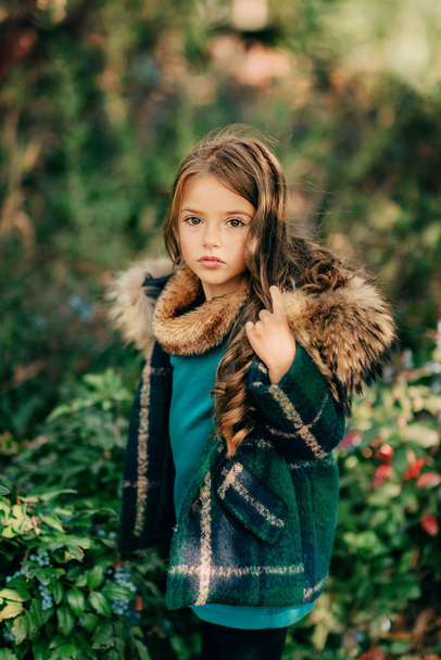 in autumn forest little girl with long hair - Fotó, kép