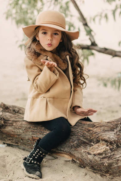 little girl in a hat with long hair - Fotó, kép