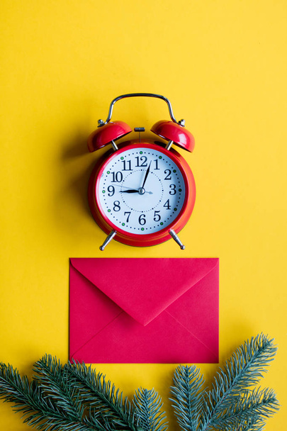 Red christmas envelope and little alarm clock - Fotografie, Obrázek