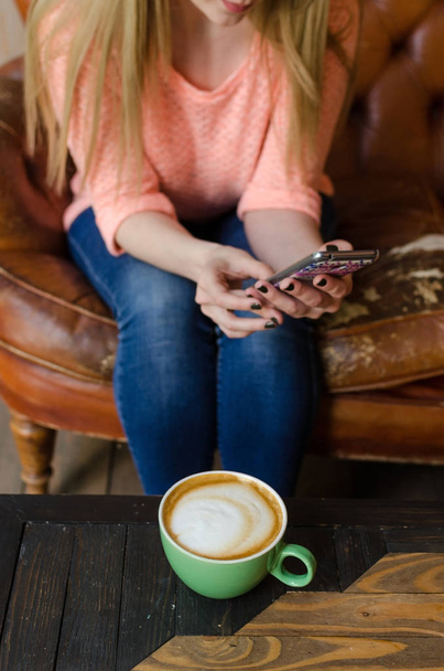 Young woman with coffee and phone - Photo, Image