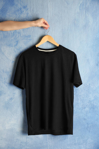 black t-shirt against grunge wall - Foto, Imagem