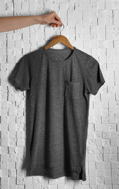 gray t-shirt against brickwall - Foto, Imagen