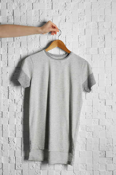 gray t-shirt against brickwall - 写真・画像