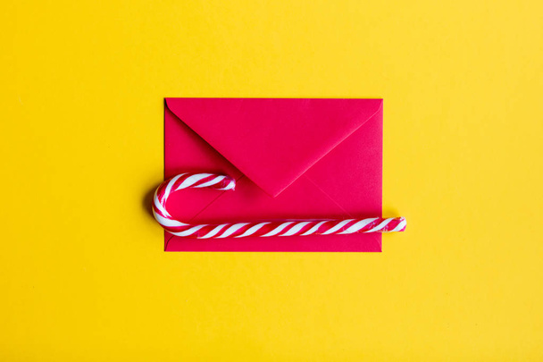 Red christmas envelope and lolipop  - Photo, Image