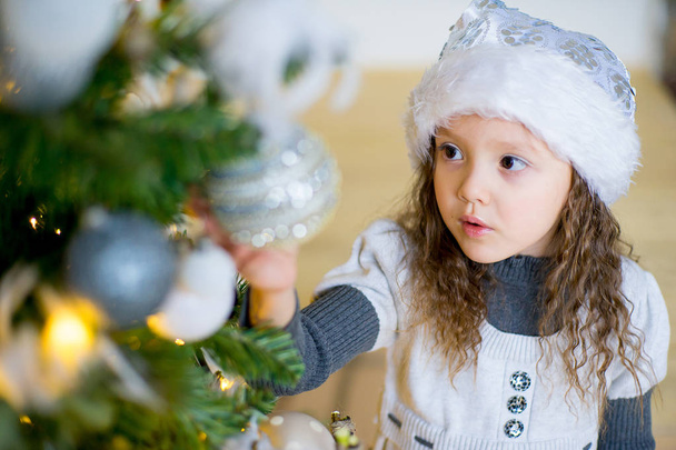 portrait of a girl near the Christmas tree - Fotografie, Obrázek