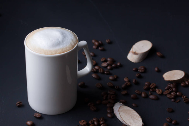 a mug of latte coffee on a black background - Valokuva, kuva