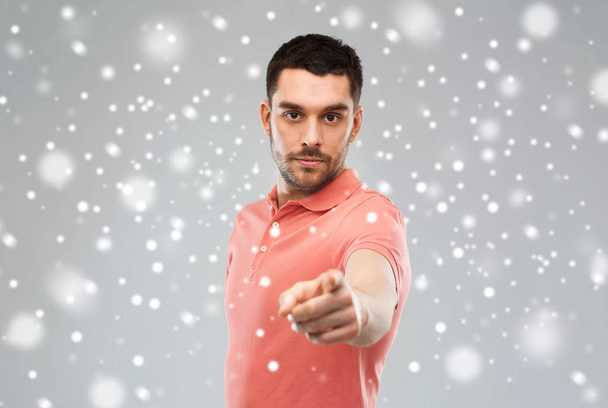 angry man pointing finger to you over snow - Foto, immagini