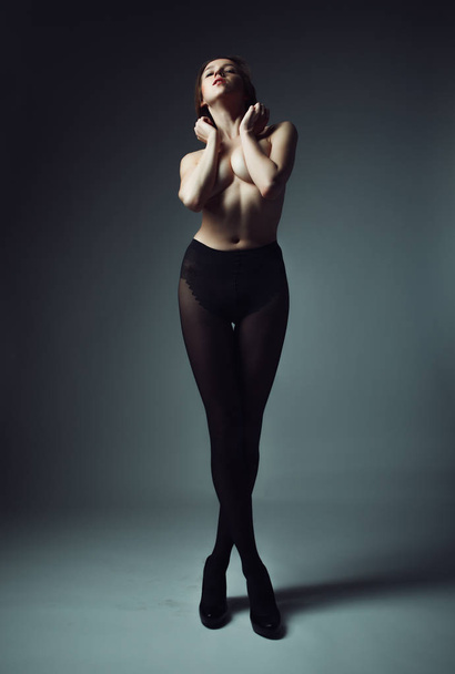model with short blond hair wearing black pantyhose - Fotoğraf, Görsel