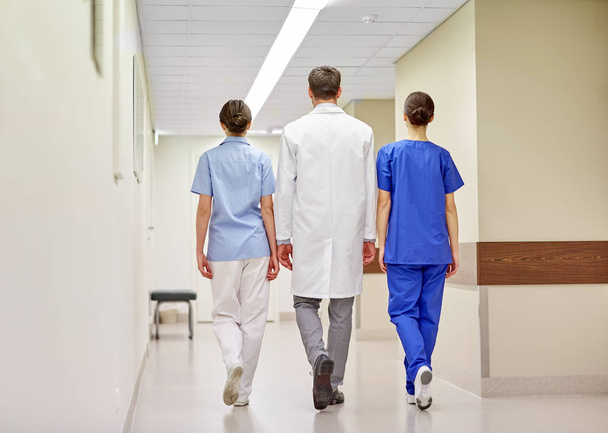 group of medics or doctors walking along hospital - Foto, Bild