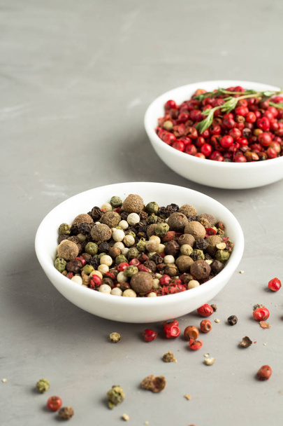 mixture of peppercorns close up on a gray background - Foto, immagini