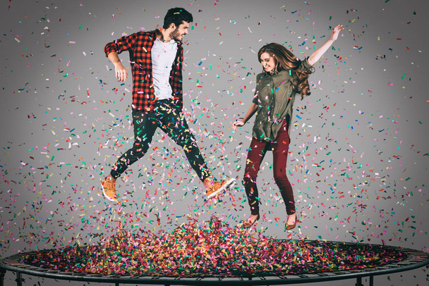 happy couple jumping on trampoline  - Zdjęcie, obraz
