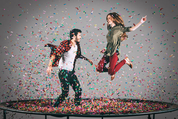 happy couple jumping on trampoline  - Foto, afbeelding