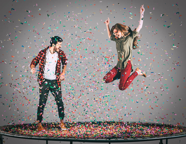 happy couple jumping on trampoline  - Zdjęcie, obraz