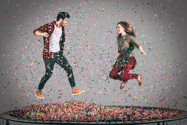 happy couple jumping on trampoline  - Foto, Imagen