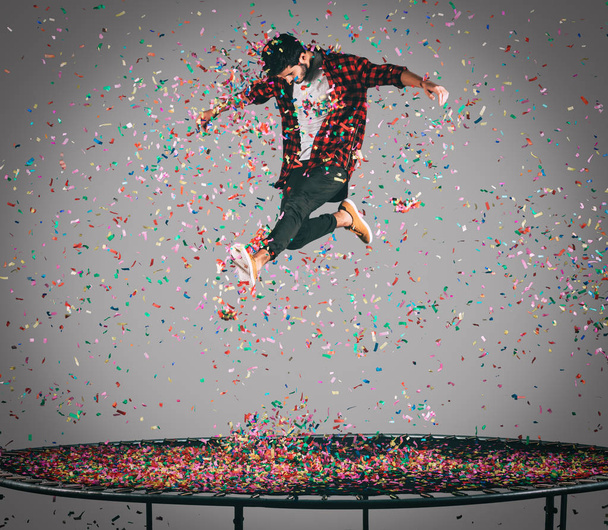 happy man jumping on trampoline  - Foto, Bild