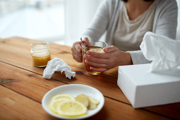 ill woman drinking tea with lemon and honey - Фото, зображення