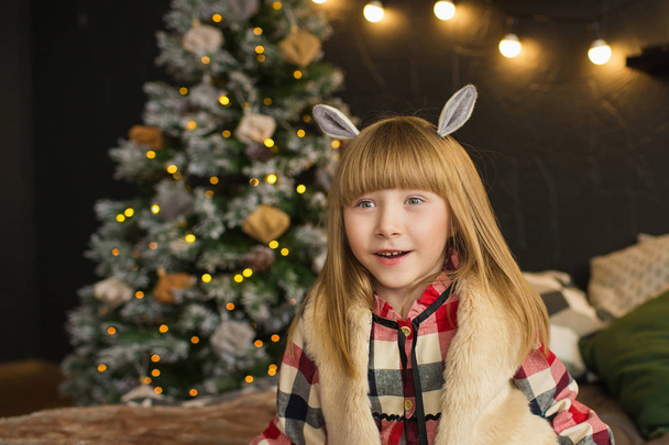 Potrait of funny little girl with an animal ears in Christmas time - Foto, Imagen