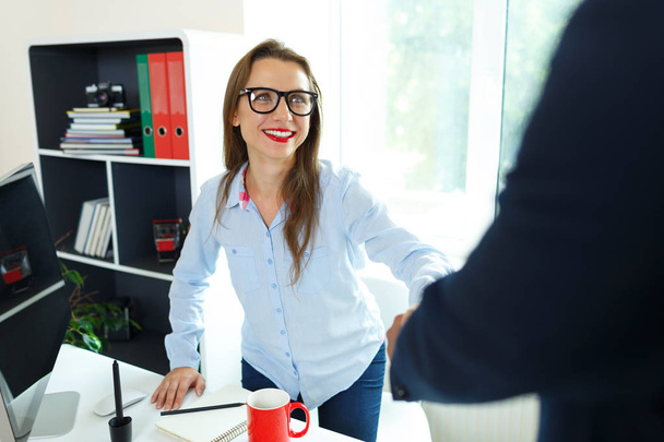 Modern business woman with arm extended to handshake - Foto, immagini
