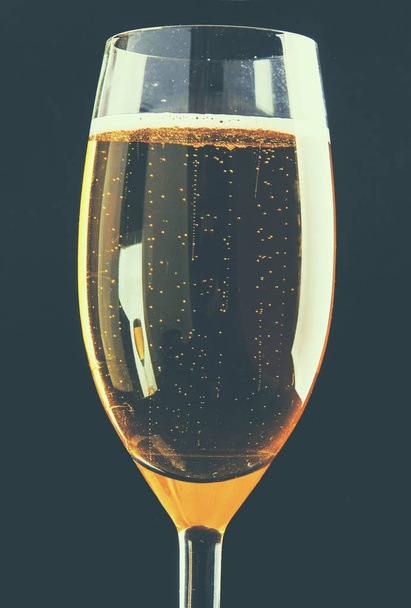Glass of sparkling shampagne wine on a black background - Фото, изображение