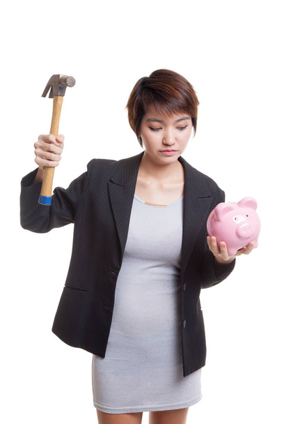 Asian business woman with pig coin bank and hammer. - Fotó, kép