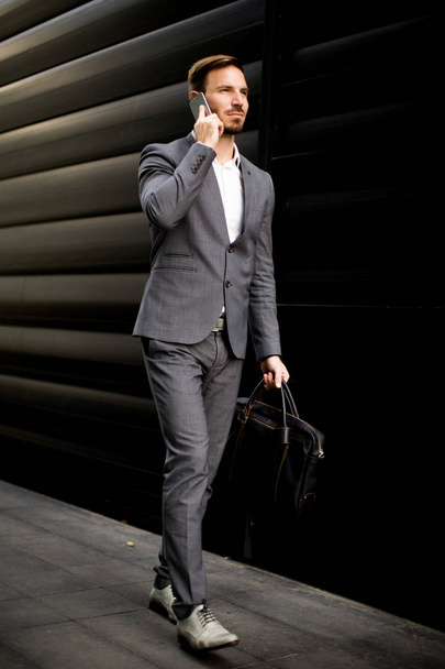 Young businessman with mobile phone - 写真・画像