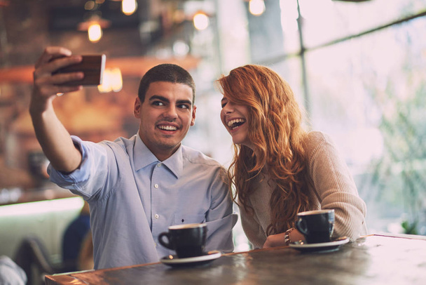 man with woman making selfie in cafe - Φωτογραφία, εικόνα