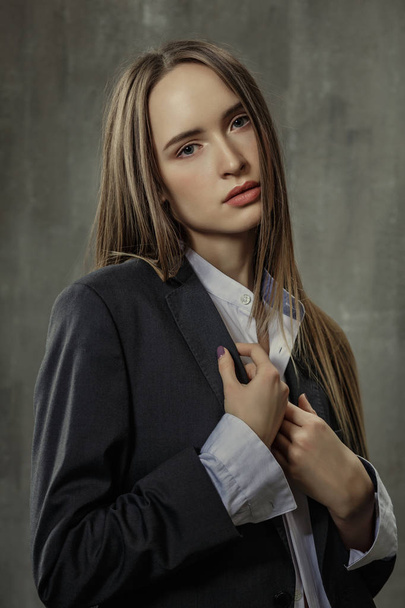 Portrait of sexy girl in classic jacket and shirt standing again - Fotó, kép