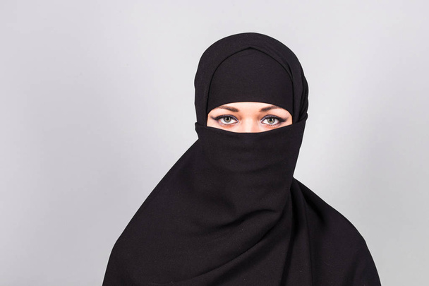 Young woman wearing niqab on background - Photo, Image
