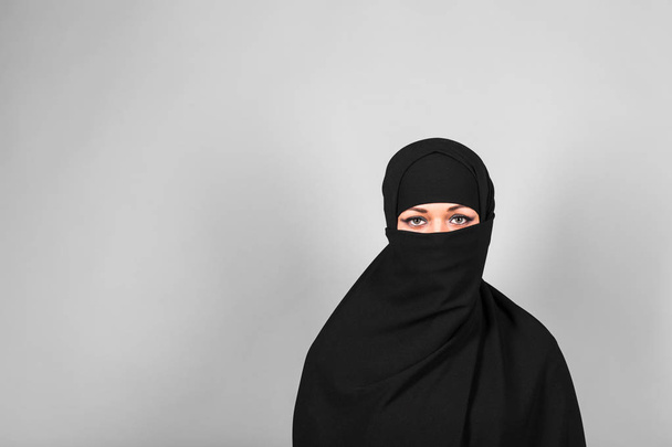 Young woman wearing niqab on background - Foto, Bild