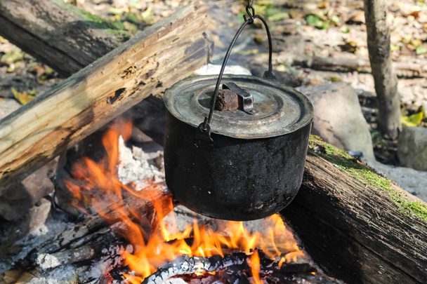 Campfire with a cooking pot stock photo containing campfire and cooking