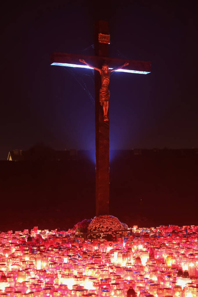 Burning candles beneath cross - Photo, Image