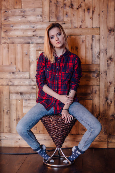 Pretty hipster girl near the wooden wall - Photo, Image
