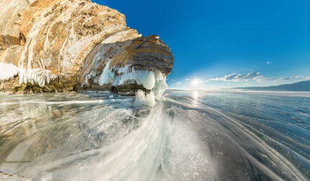 Rock on Olkhon Island on Lake Baikal ice covered wide-angle pano - Photo, image