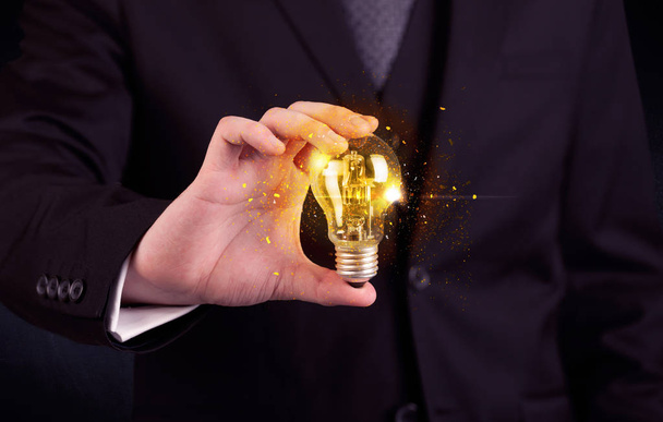 office worker holding a light bulb - Photo, Image