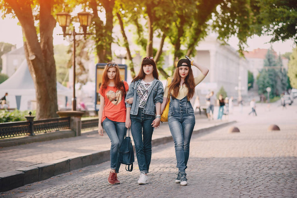 three young girls walking in the park - Фото, зображення