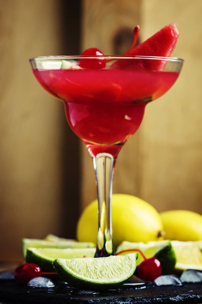 Alcoholic cocktail with watermelon, lemon, lime, tequila and ice  - Fotó, kép