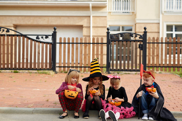 Хэллоуин дети выбирают конфеты в контейнерах
 - Фото, изображение