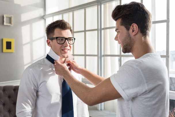 man tying a necktie for his boyfriend - Φωτογραφία, εικόνα