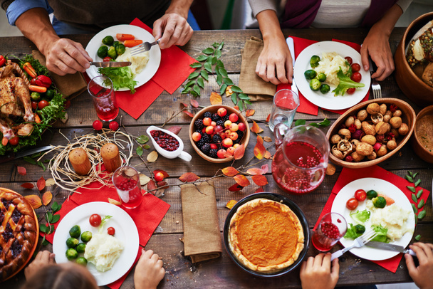 thanksgiving dinner and family eating at table  - Photo, Image