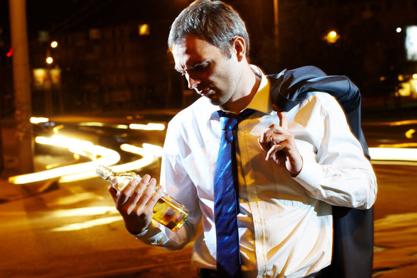 Portrait of a businessman with a bottle - Foto, afbeelding