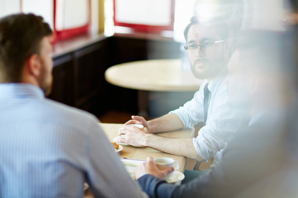 Hommes d'affaires ayant une réunion dans un café
  - Photo, image