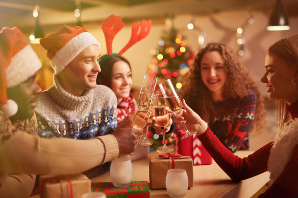 friends toasting with champagne on Christmas evening - 写真・画像