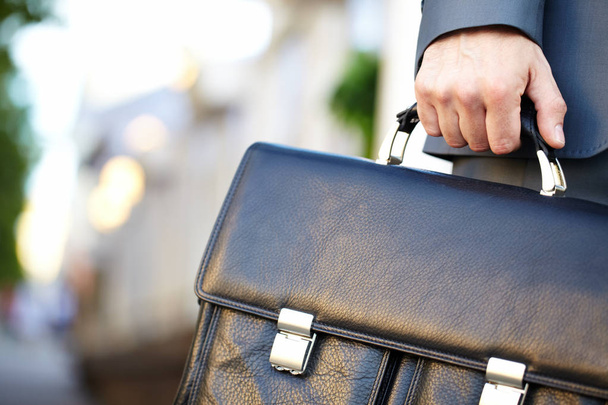 Leather briefcase held by a man - Foto, Imagen