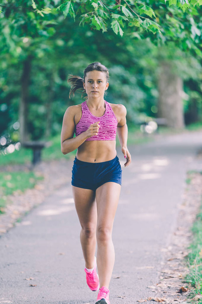 Woman Runner athlete running at park.  - Zdjęcie, obraz