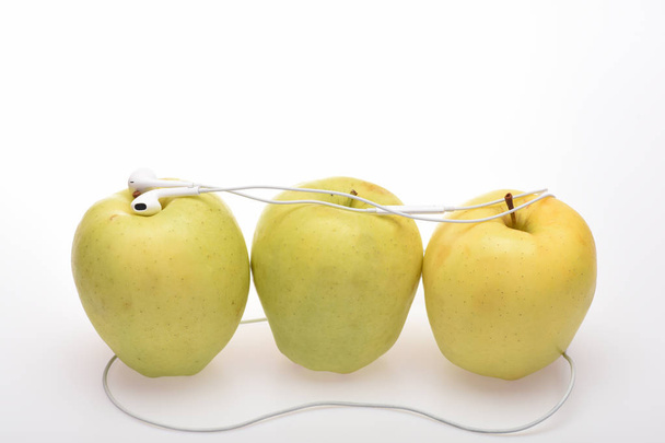 Yellow apple and headphones - Фото, зображення